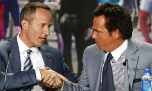 Chris Ilitch and Tom Gores shaking hands