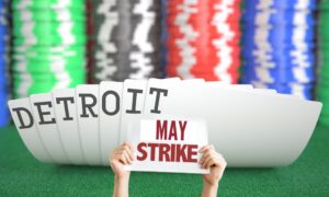 Image of playing cards spelling out Detroit, where casino workers voted to authorize a strike