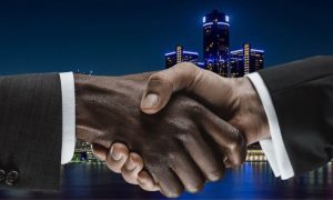 Image of two hands shaking in front of Detroit skyline for story on a settlement that may end the Detroit casino workers' strike