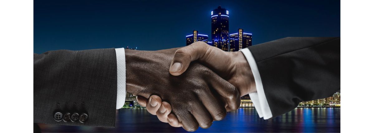 Image of two hands shaking in front of Detroit skyline for story on a settlement that may end the Detroit casino workers' strike