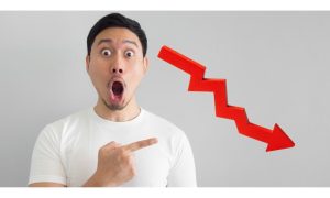 Image of shocked man pointing at downward arrow for story on Detroit casino revenue for October being hurt by the workers' strike