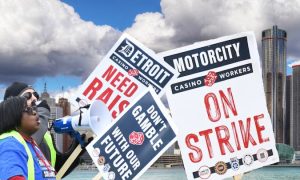 Image of Detroit casino workers on strike in front of Detroit skyline for story on how the strike gave Detroit casinos their worst month of revenue — October 2023 — since 2020
