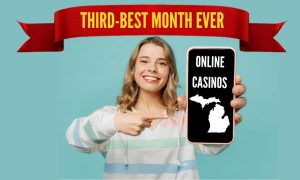Image of girl holding phone with "online casinos" and Michigan outline for story on Michigan online casinos October 2023 revenue