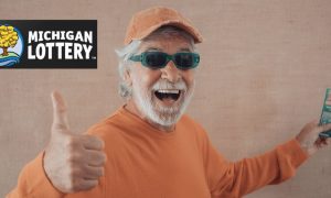 Image of man giving thumbs up next to Michigan Lottery logo for story on how there are Millions In Michigan Lottery Scratch-Off Prizes Available For Holiday Season