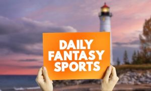 Sign saying daily fantasy sports in front of Michigan lighthouse for story on PrizePicks Returning To Michigan With Free-To-Play Daily Fantasy Sports Product