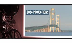 A projection screen projects the Mackinaw Bridge along with a title of 2024 projections.