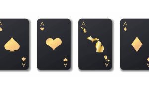 Four black and gold playing cards, all aces, except the club has been replaced with an outline of Michigan. Poker rooms across the state are holding a wide variety of tournaments before 2023 ends.