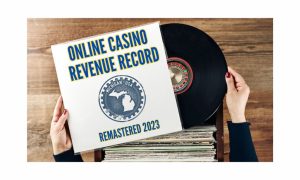 Vinyl record being removed from its sleeve. The sleeve reads "Online Casino Revenue Record" and "Remastered 2023" with a Michigan logo in the middle to indicate Michigan Online Casinos set a new monthly revenue record in December of $181.4 million, pushing it to a record $1.92 billion for 2023.