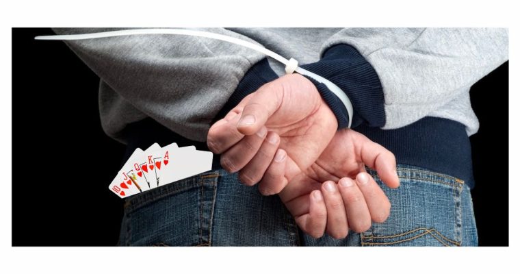 Man with hands zip-tied behind his back and playing cards sticking up from his back pocket. A Michigan poker champ says he was abducted and extorted for his gambling winnings. The FBI is investigating.