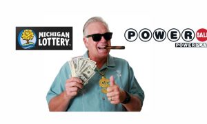Man wearing sunglasses, smoking a cigar, holding a stack of money and wearing a dollar-sign necklace after Michigander cashed a Powerball ticket worth $842 million
