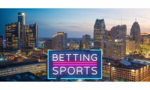 Neon sign that reads "Betting Sports" is shown over a skyline shot of the city of Detroit. Retail sports betting at Detroit casinos continued a steady decline in 2023