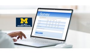 Person filing out an online survey on a laptop. There is a University of Michigan C.S. Mott Children's Hospital logo on the wall. A hospital study on teenagers and gambling reveals a gap in knowledge among parents