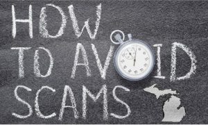"How to avoid Scams" written in chalk on a chalkboard beside a chalk outline of the state of Michigan to go with a story about the Michigan Attorney General reminding sports bettors to be careful about where they bet their money