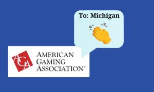 American Gaming Association logo with a text message bubble that reads: "To: Michigan" with the clapping emoji. The American Gaming Association's Revenue Tracker notes Michigan is a top online casino state and Detroit is a leading casino jurisdiction.