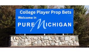 Blue highway welcome sign that reads: "College Player Prop Bets Welcome in Pure Michigan." Ohio has moved to ban all NCAA player prop bets, but Michigan still allows legal wagers on the performance of college athletes.