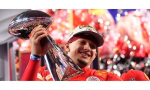 Kansas City Chiefs QB Patrick Mahomes holding the Vince Lombardi trophy after winning the 2024 Super Bowl. While the Super Bowl game broadcast featured limited gambling advertisements, they were prevalent during the four-hour pregame.