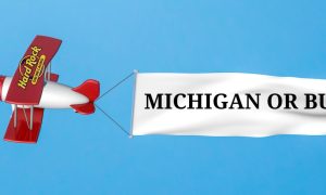 Biplane with the Hard Rock online casino logo on its wing is pulling a banner that reads "Michigan or bust" Hard Rock's purchase of 888's US assets increases the likelihood the former will replace the SI online casino and sportsbook in Michigan.