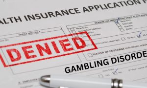 Health insurance application form with "Gambling Disorder" typed on it and a large red stamp reading "denied." Problem gamblers are facing institutional bias when it comes to receiving equal health care as other dependencies or physical ailments.