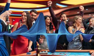 A group of people cheering and enjoying themselves while at a casino roulette table. There is a large, bright blue musical wave that indicates great, fun music is playing. Two experts with ties to Michigan casinos tell PlayMichigan that the music played in casinos is incredibly important to the bottom line.