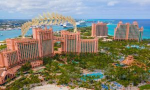 Atlantis Bahamas hotel with a Caesars golden laurel on top. Twenty-five lucky Caesars Palace online casino players in Michigan will win an Atlantis Bahamas Getaway Package.