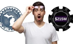 Man with an astonished face stands in front of a Michigan logo and a large casino chip with $215M on it. March was the best month ever in online casino revenue with $215.2 million. It was the first time Michigan has surpassed $200 million.