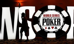 Man walks past a WSOP sign. WSOP is the first Michigan online poker platform to offer a three-state prize pool thanks to its launch with New Jersey and Nevada.