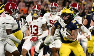 University of Michigan football player Blake Corum runs for a touchdown against Alabama in the 2024 Rose Bowl. The discussion on rules, regulations, and compliance comes as the MGCB considers bans on prop bets on college sports.