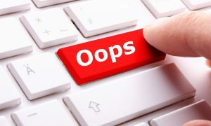 Person pushing the "oops" button on a computer keyboard. In an attempt to clear up a mistaken email, Bovada sent a follow-up clarifying that Michigan users have been alerted of a shutdown.