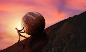 Man pushing a large boulder uphill. Hard Rock has jumped up to fifth nationally among sportsbook operators, but it faces an uphill climb in a mature Michigan market.