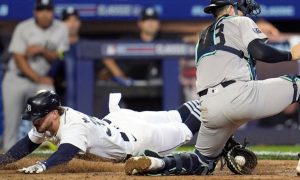 Detroit Tigers' Zach McKinstry slides head first past New York Yankees catcher Austin Wells. Michigan sportsbooks produced a record for July handle and revenue despite a quieter sports calendar and a mature sports betting market.
