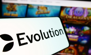 Evolution logo over a phone in front of collection of iCasino games
