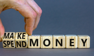 lettered tiles spelling "make money" and "spend money"