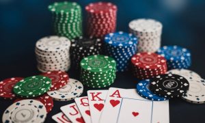 stacks of poker chips surrounding a royal flush poker hand