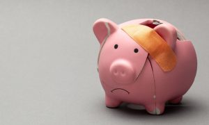 a broken piggy bank with a band-aid on it