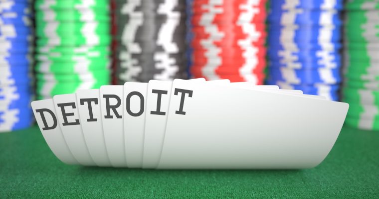 a hand of cards that spells out Detroit