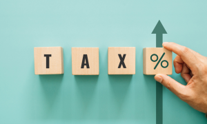 a set of blocks that spell out tax percentage with an arrow pointing up