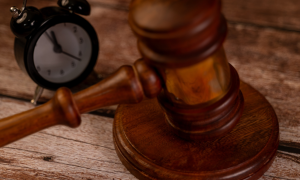 a gavel next to an alarm clock