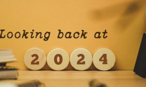 circle blocks spelling 2024 with looking back at written on a yellow background