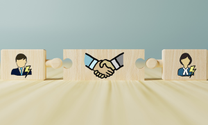 puzzle pieces separated that show two people and a handshake