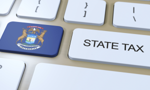 a keyboard with a Michigan flag icon next to a key with state tax written on it