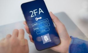 a mobile phone with a two-factor authentication notice appearing on it.