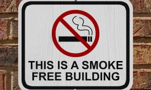 a no smoking sign attached to a building