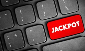 a keyboard with a red jackpot button on it