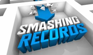 a blue arrow smashing through walls toward the words smashing records