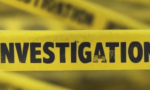 yellow police tape with investigation written on it