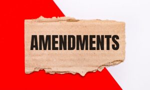 a red and white background with a tear in it that reveals the word amendments