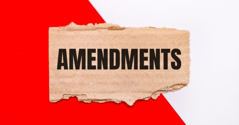 a red and white background with a tear in it that reveals the word amendments