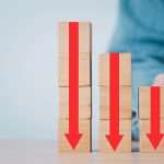 Stack of blocks with red arrows pointing down, illustrating declining casino revenue