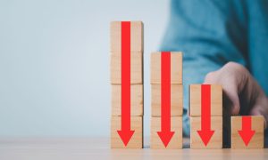 Stack of blocks with red arrows pointing down, illustrating declining casino revenue