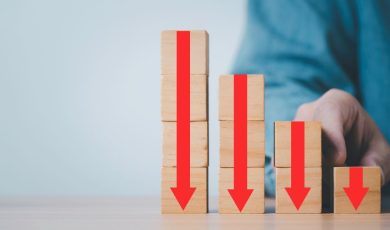 Stack of blocks with red arrows pointing down, illustrating declining casino revenue